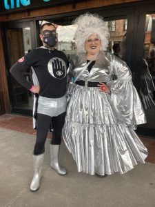A couple in costume, in front of a movie theater
