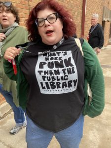 Woman wearing a T-shirt that says, "What's more PUNK than the public library"